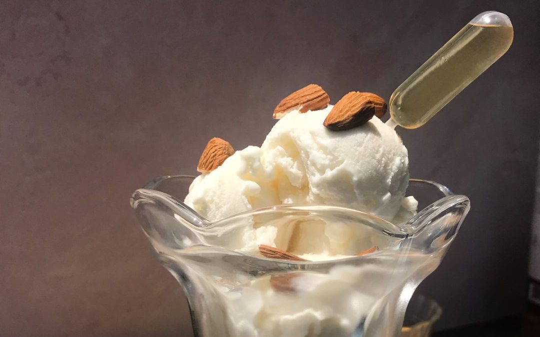 no churn vanilla ice cream topped with almonds and a vile of amaretto
