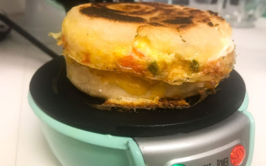 A cooked tex-mex breakfast sandwich in the sandwich makers