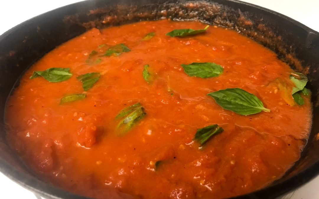 tomato butter sauce with basil simmering in skillet