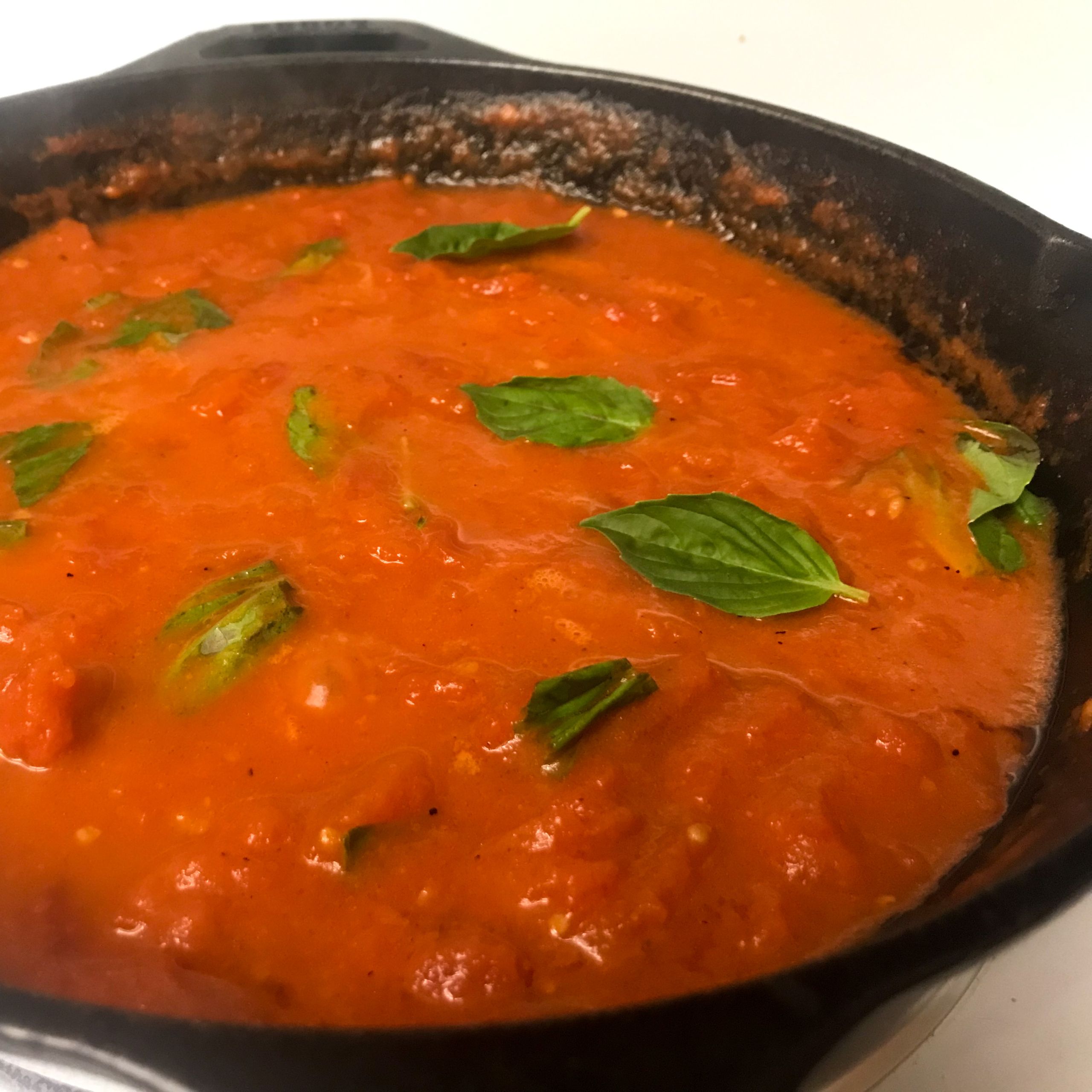 tomatoes and basil simmering on stove