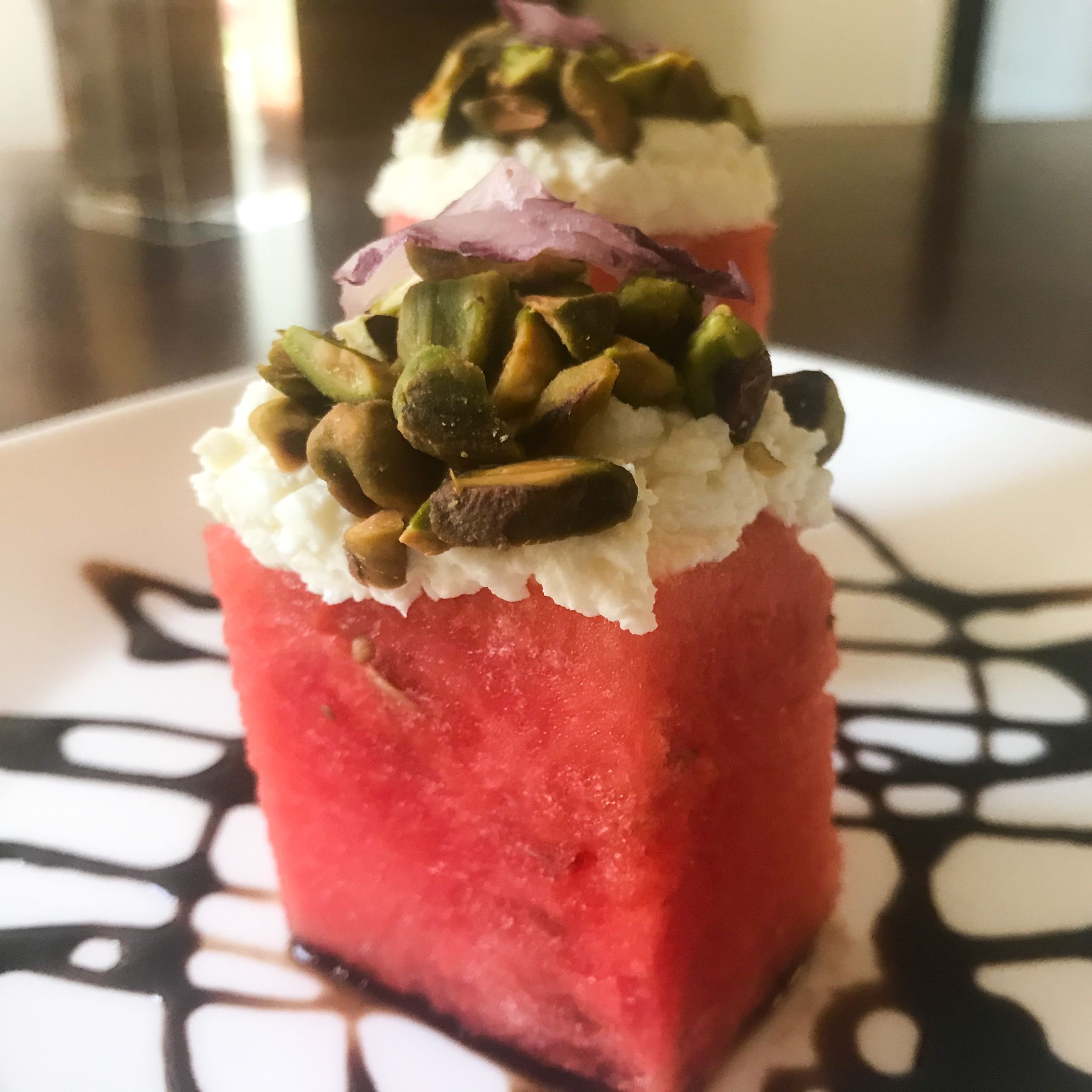 finished watermelon stacks with feta and pistachios and balsamic glaze