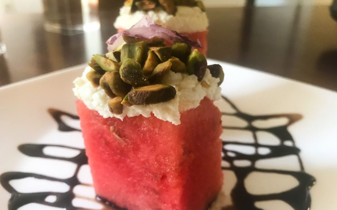 Watermelon stacks topped with whipped feta, pistachios and shaved red onion