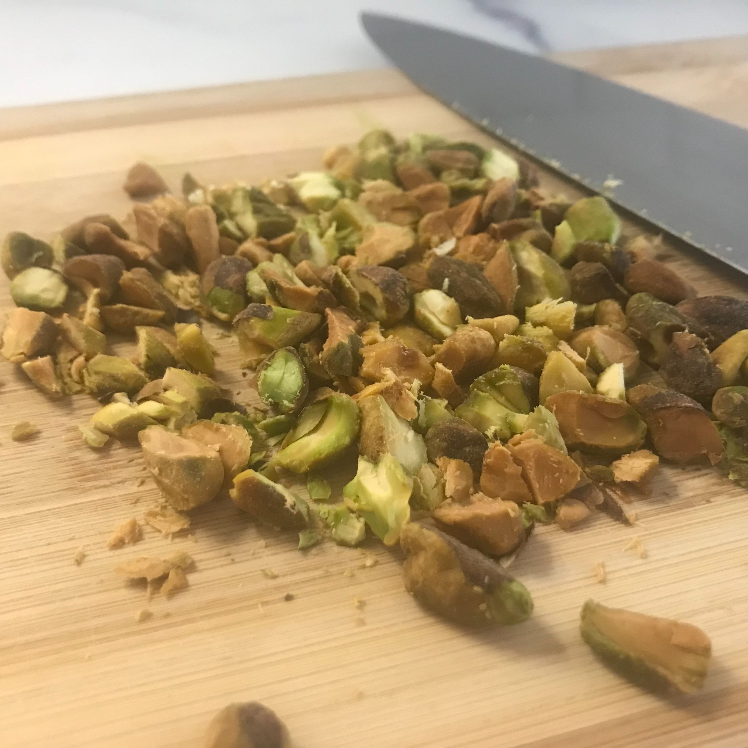 chopped toasted pistachios on cutting board