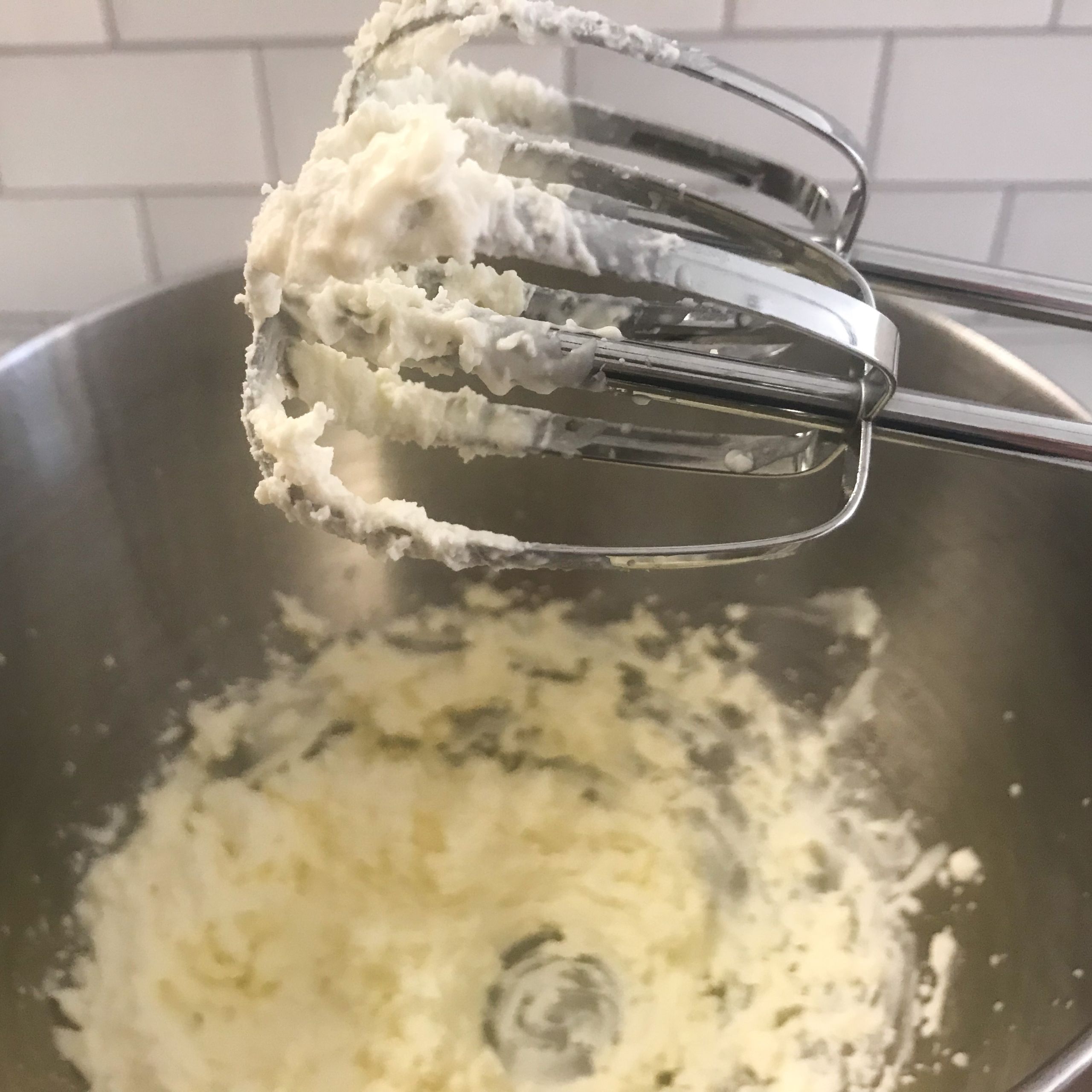 Bowl of whipped feta wi hand mixer