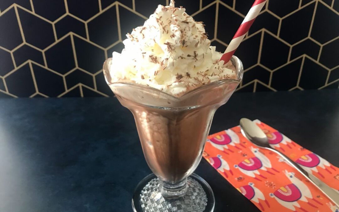 Frozen hot chocolate with a straw and spoon