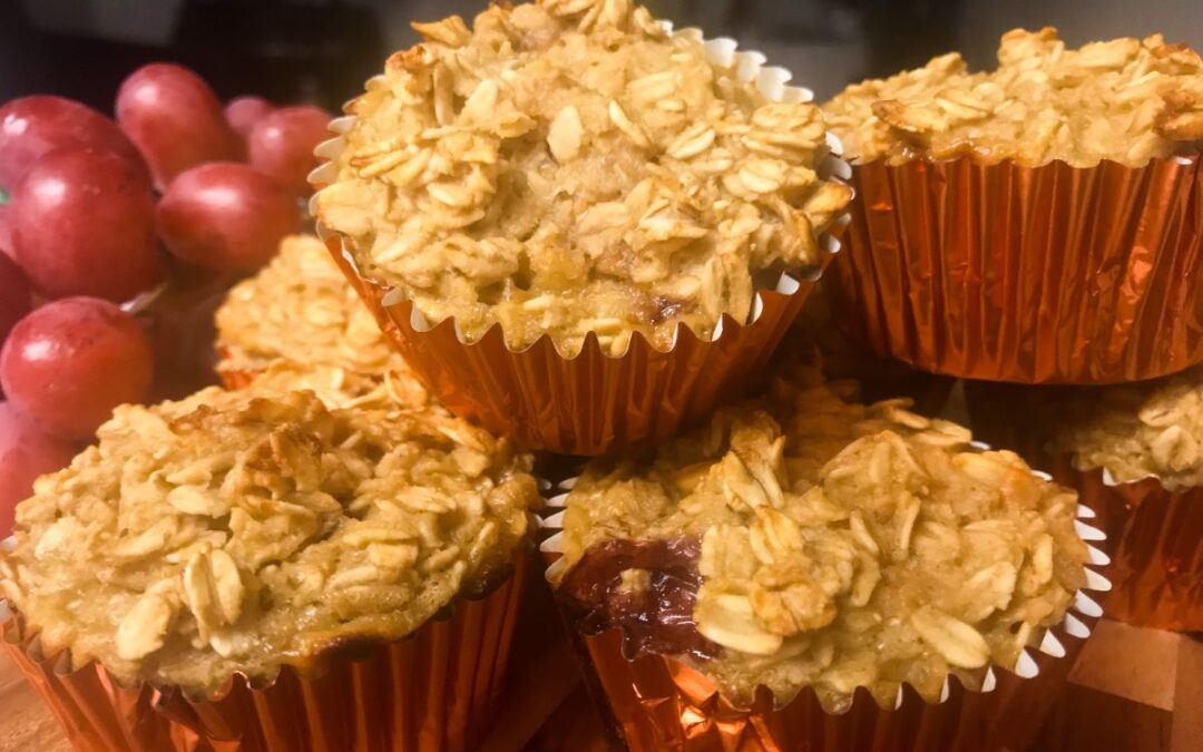 peanut butter and jelly oatmeal muffins on a platter with grapes