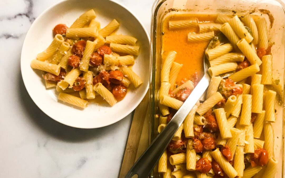 bowl of pasta next to baking dish of mozzarella cherry tomato rotini