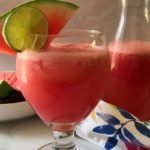 Glass and pitcher of watermelon agua fresca.