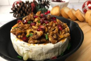 baked brie with walnuts honey and brown sugar on a plate.