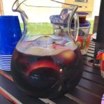 Pitcher of sangria on table with cups