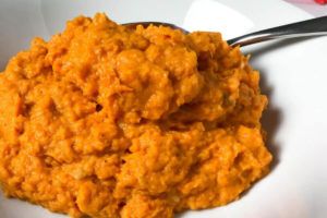 Whipped roasted garlic sweet potatoes in a bowl.