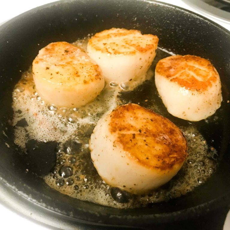 scallops cooking in a skillet.