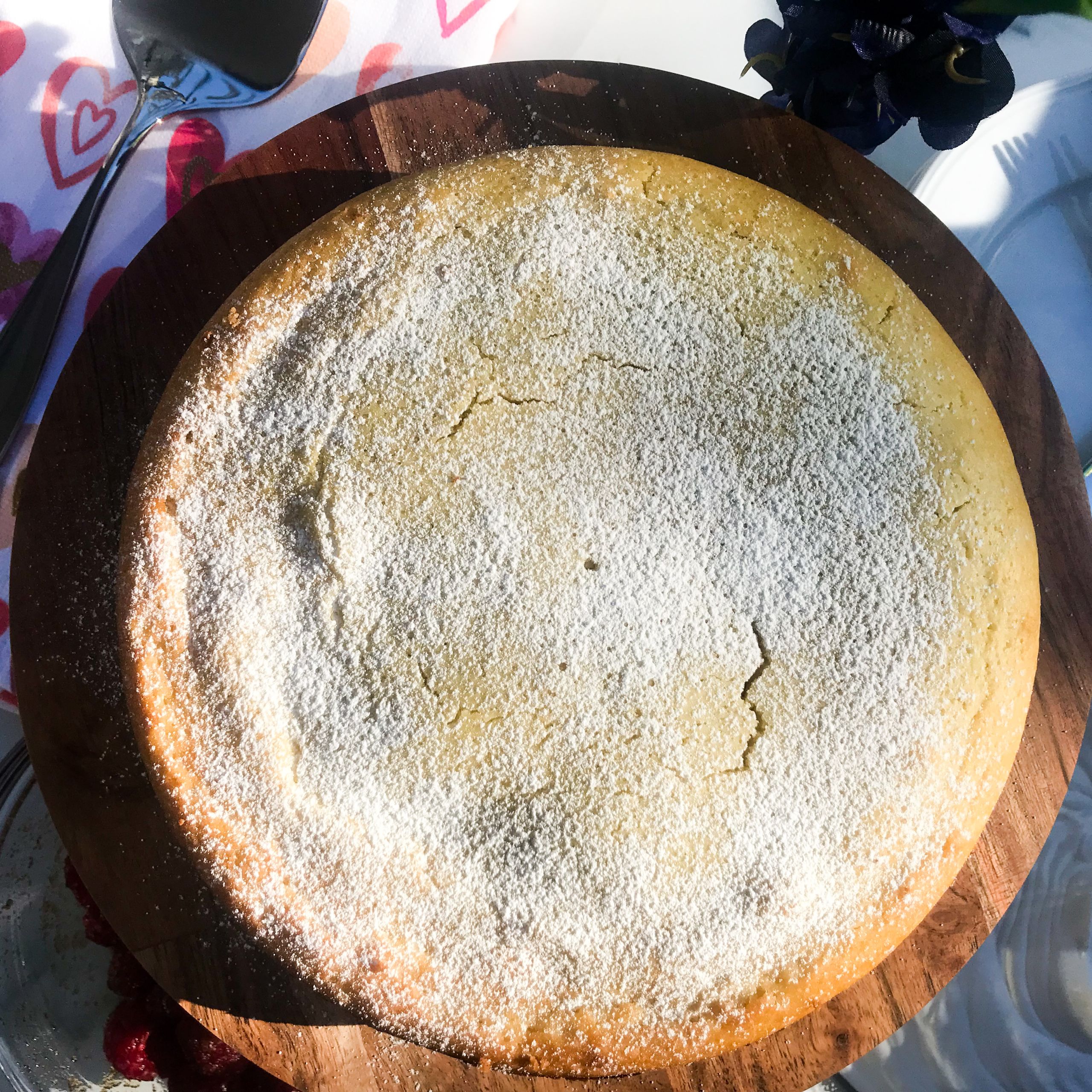 overhead view of lemon olive oil cake on a stand