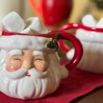 a santa mug filled with hot chocolate and marshmallows.