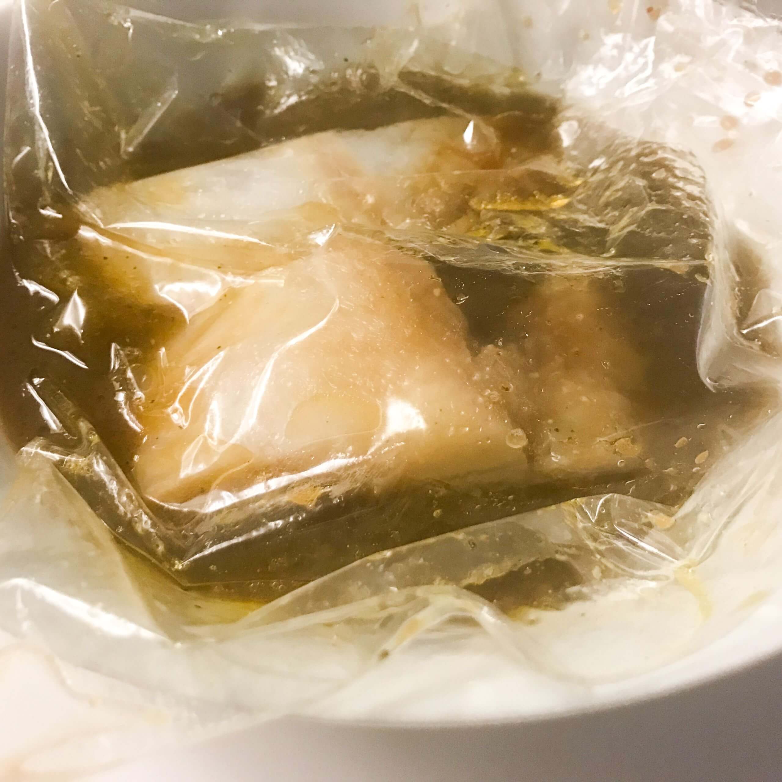 cod marinating in plastic bag | my curated tastes