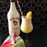pina colada with bottle of rum.