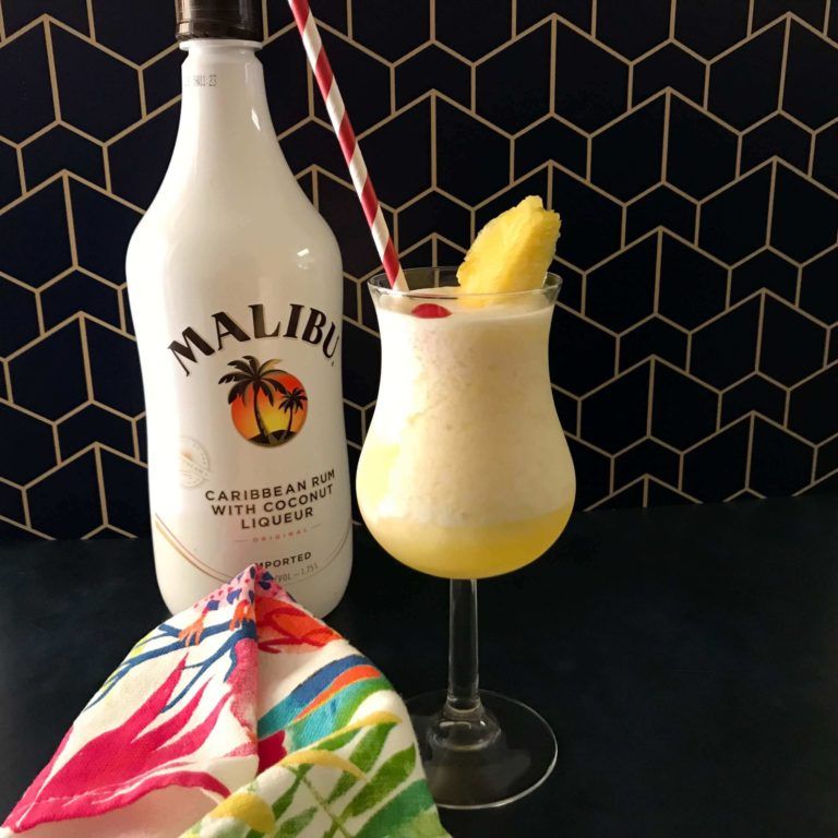 Pina colada with bottle of rum.
