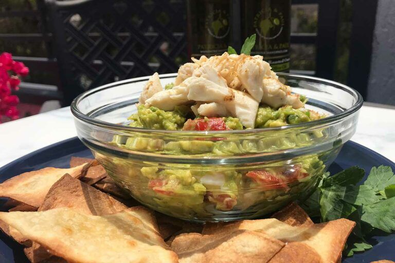 bowl of crab guacamole dip with chips