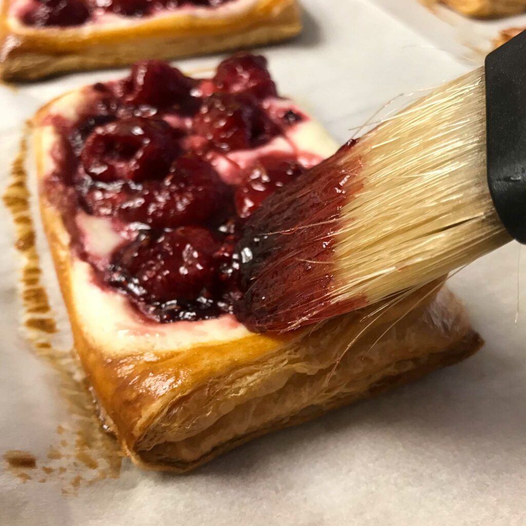 brushing baked pastry with glaze.