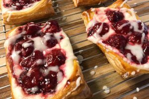 Raspberry Puff Pastry Tarts on a rack.