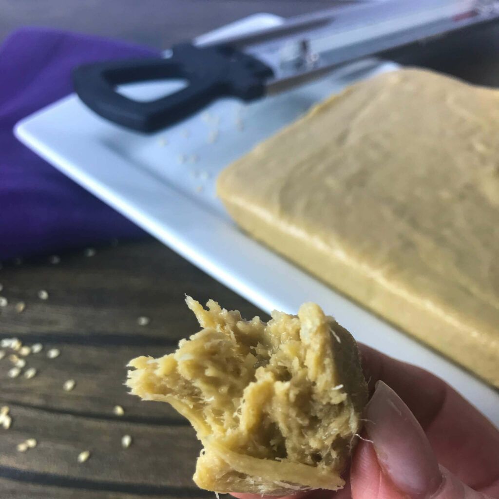 a piece of halva being held in fingers.