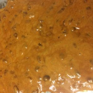 Microwave Peanut Brittle poured onto baking sheet.