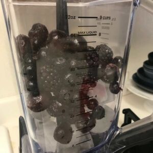 Blender with ice and berries.