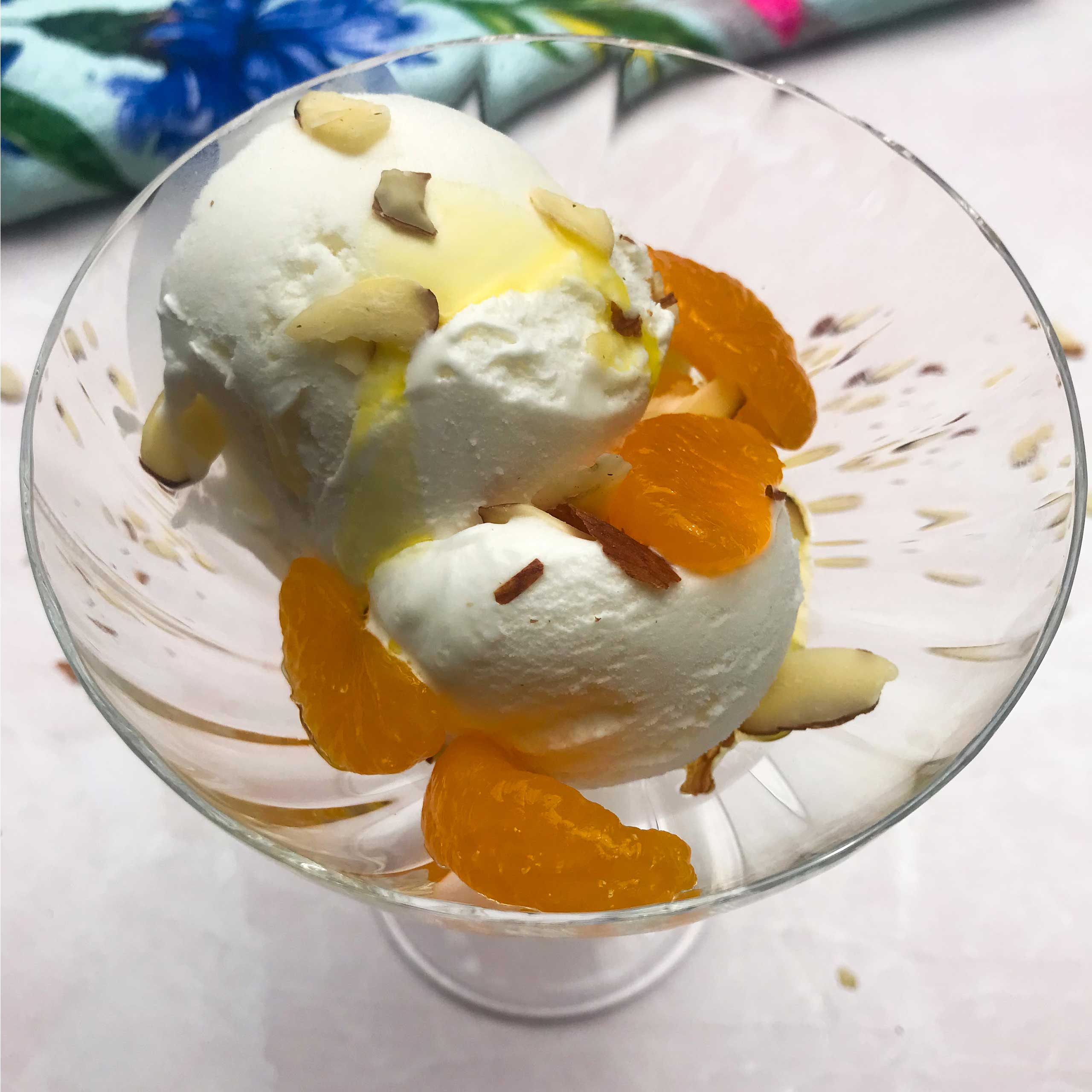 glass of ice cream with olive oil, almonds and mandarin oranges