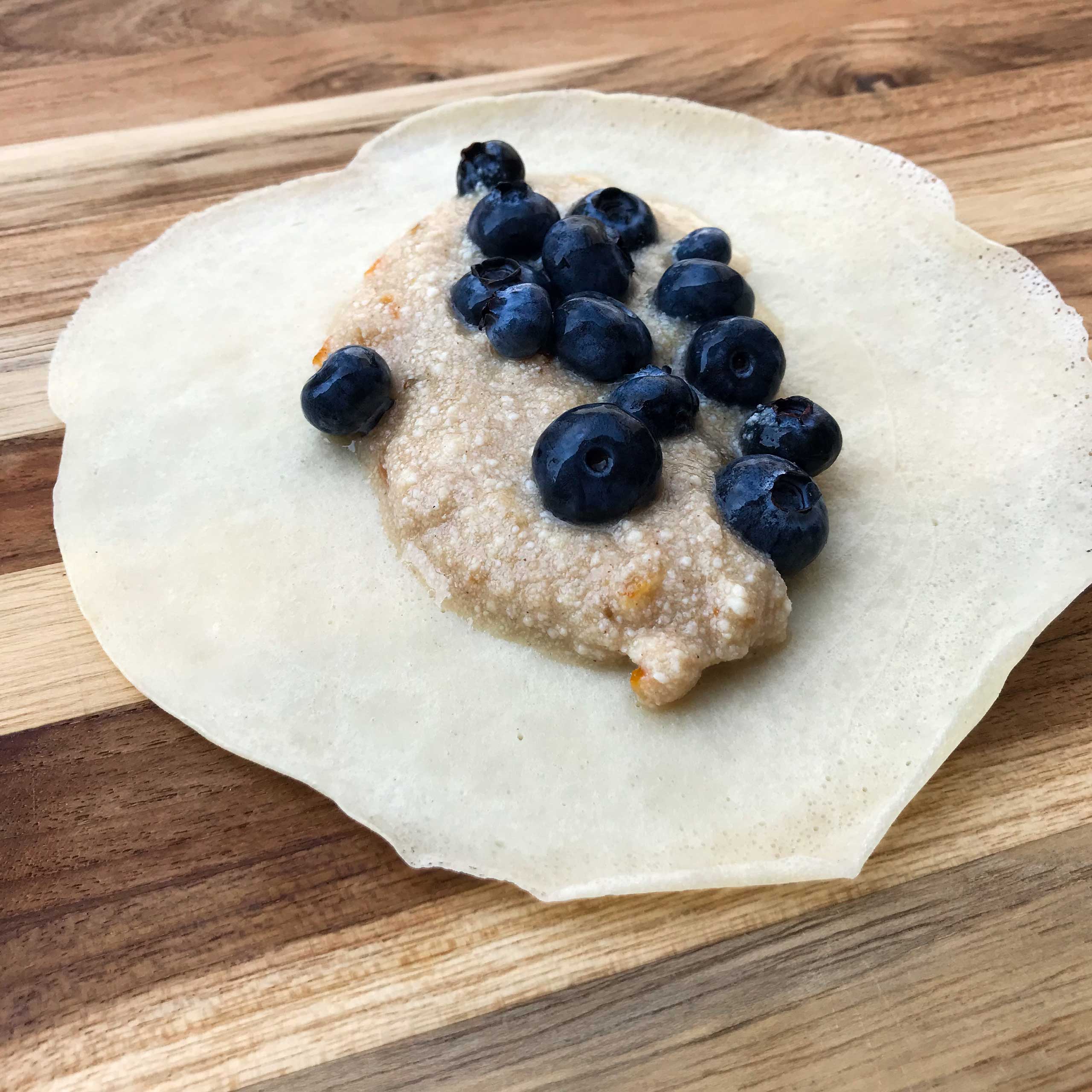 crepe topped with filling and blueberries