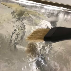 brushing baking sheet with olive oil.