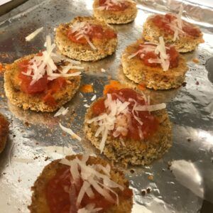 eggplant topped with sauce and parmesan cheese.