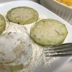 eggplant slices in flour.