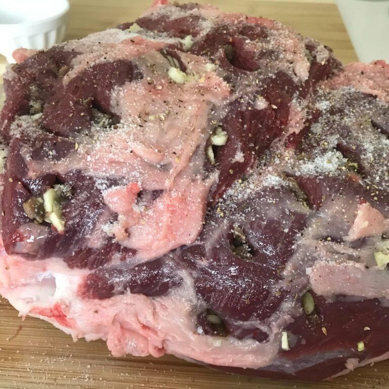 Raw Leg Of Lamb With with slits filled with Garlic and anchovy