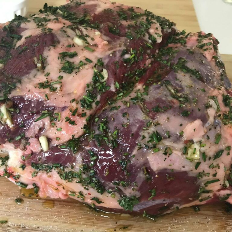 leg of lamb covered in herb marinade