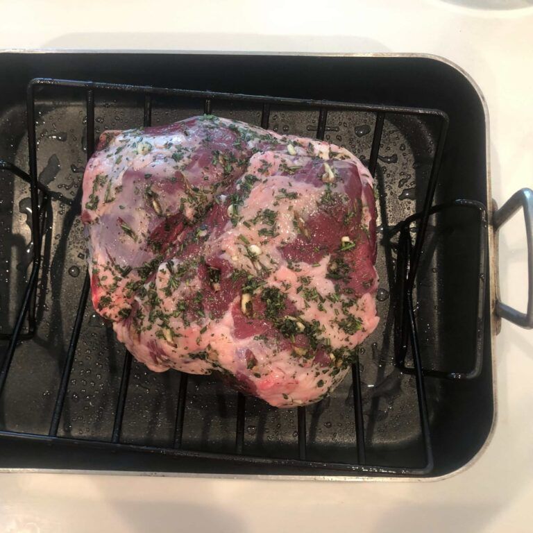 prepped leg of lamb in a roasting pan