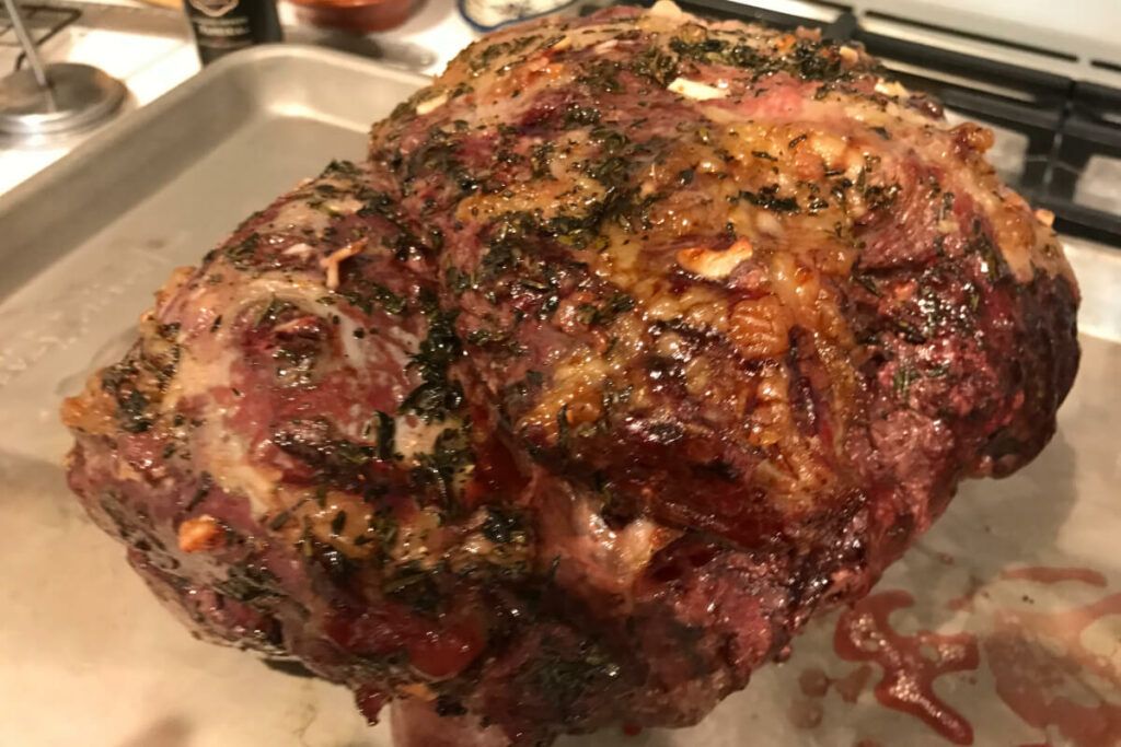 Leg Of Lamb With Garlic Gravy resting on tray