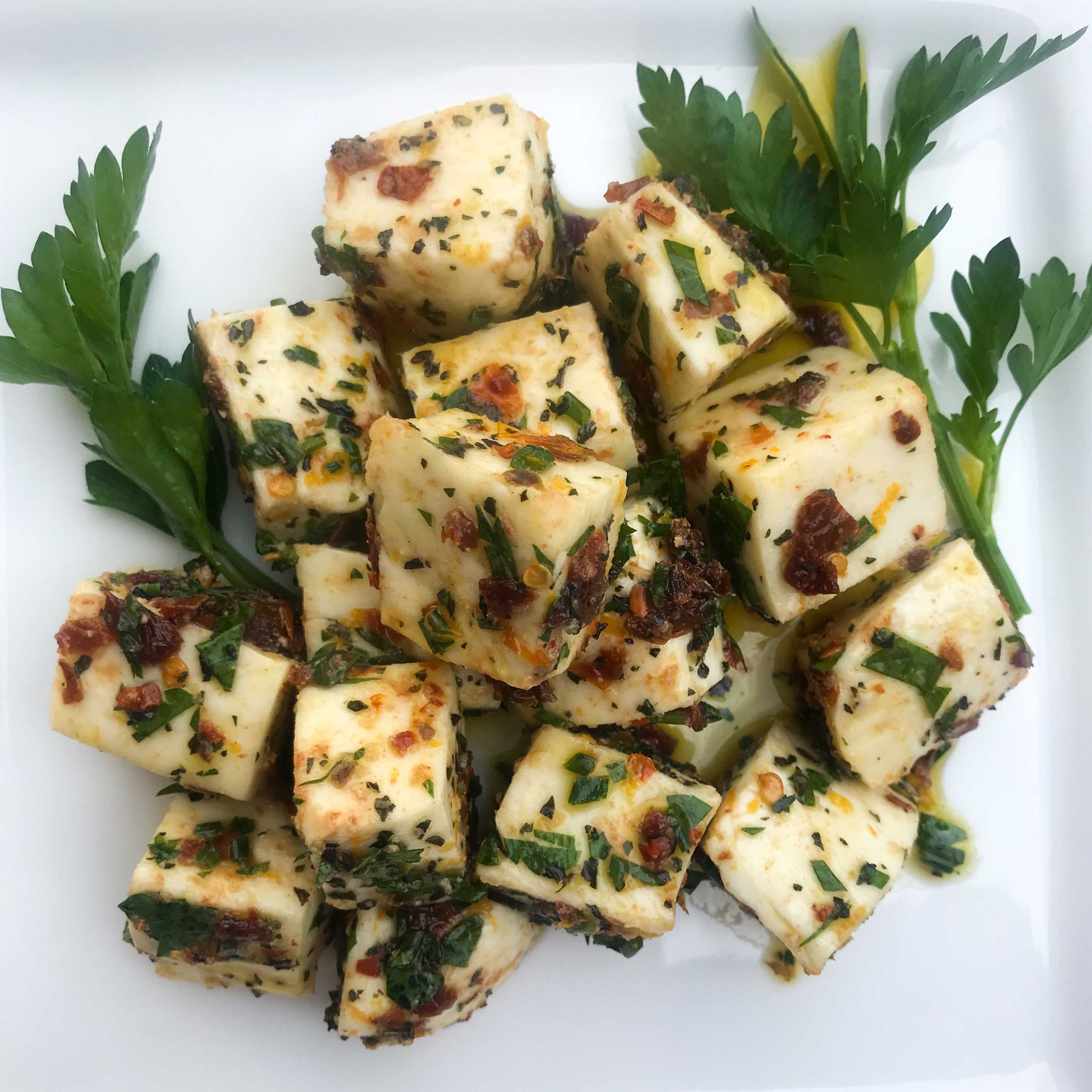 overhead view of a plate of Marinated Mozzarella Cubes