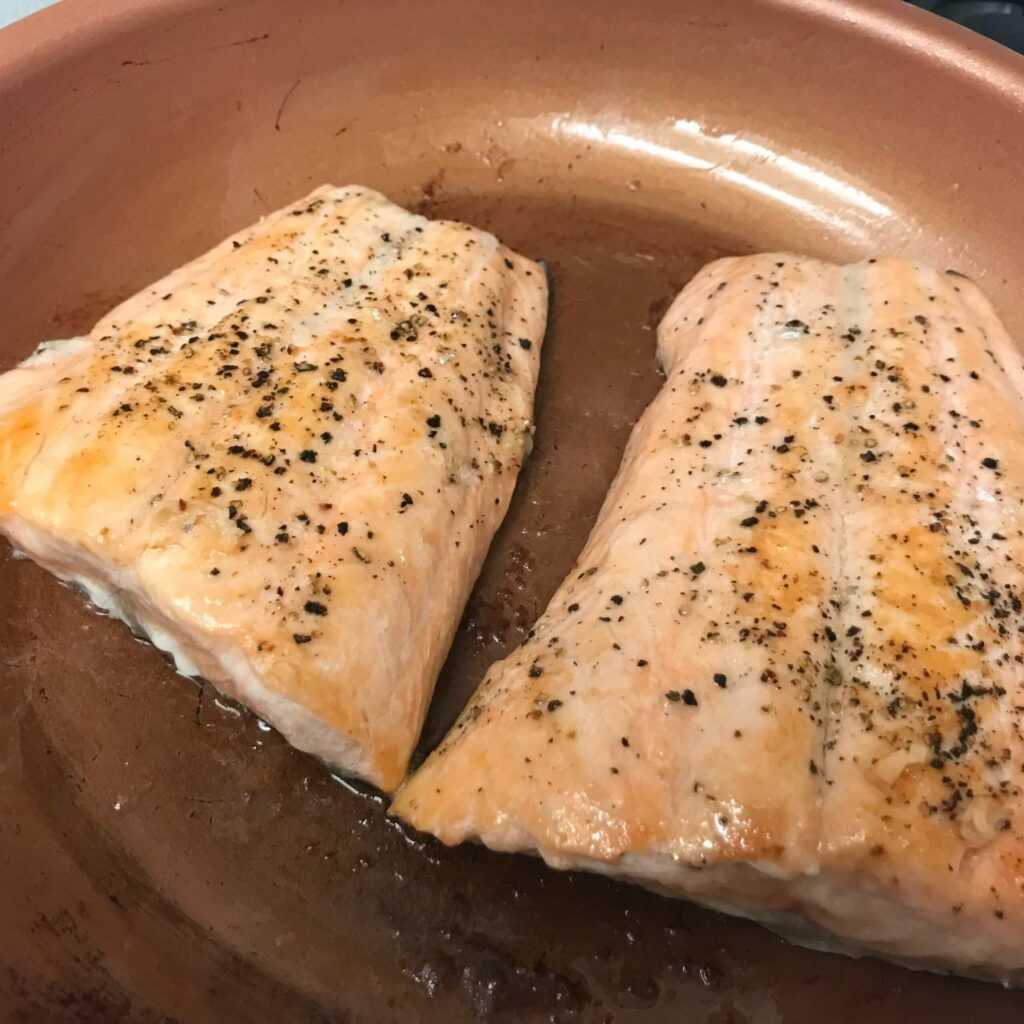 salmon cooking in skillet.
