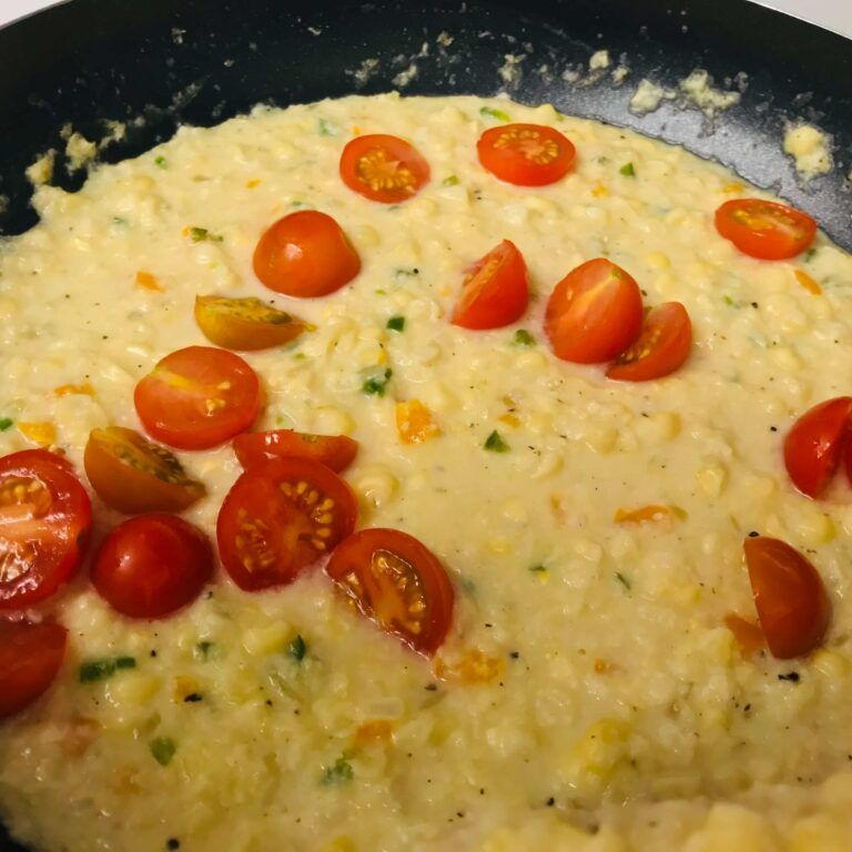 corn puree and sliced tomatoes in skillet.