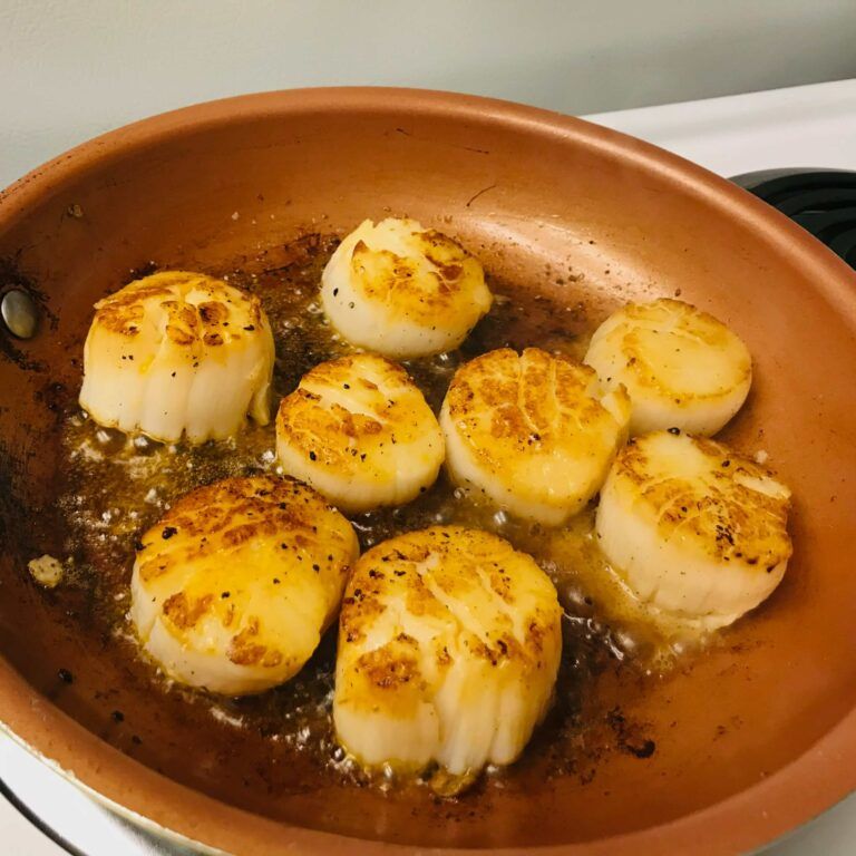 scallops cooking in skillet.