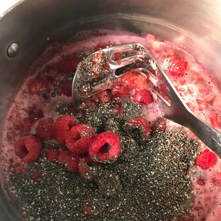 chia seeds and whole berries added to mashed berries.