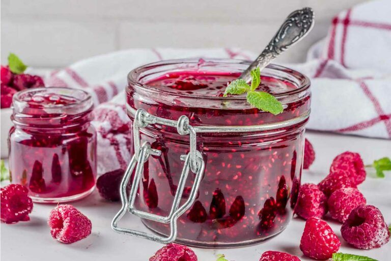 sugar free jarred raspberry jam with a spoon.