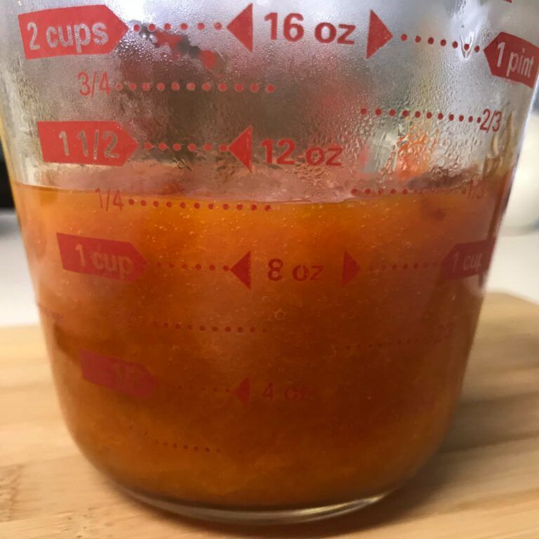 finished jam in a measuring cup