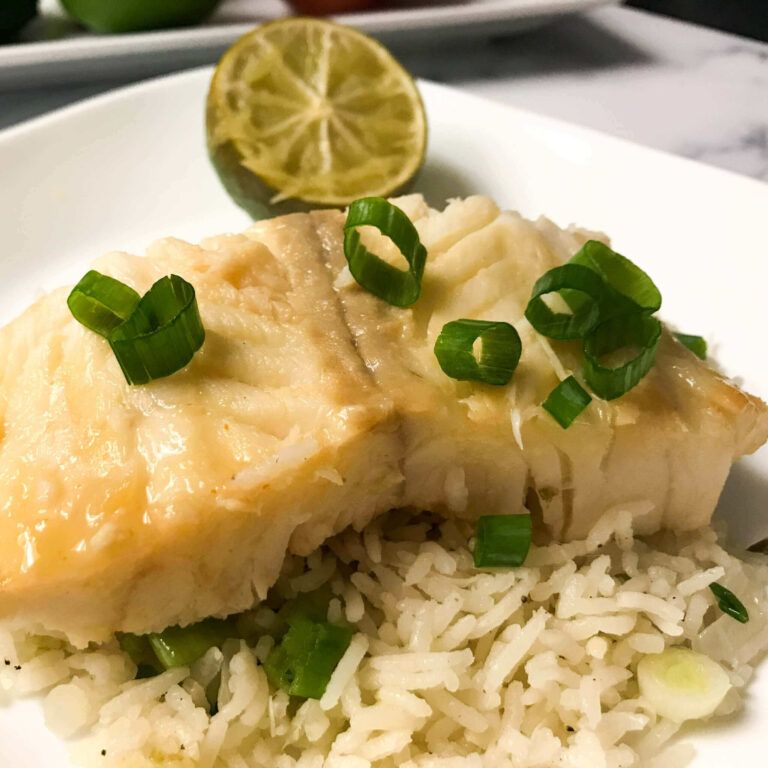 finished dish of cod on rice with a lime half