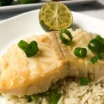 cooked cod on top of rice