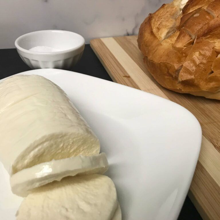 plate of sliced mozzarella and loaf of sliced bread