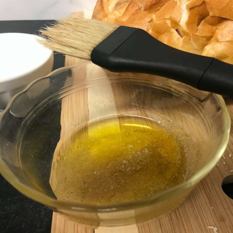 small bowl of seasoned oil with a brush