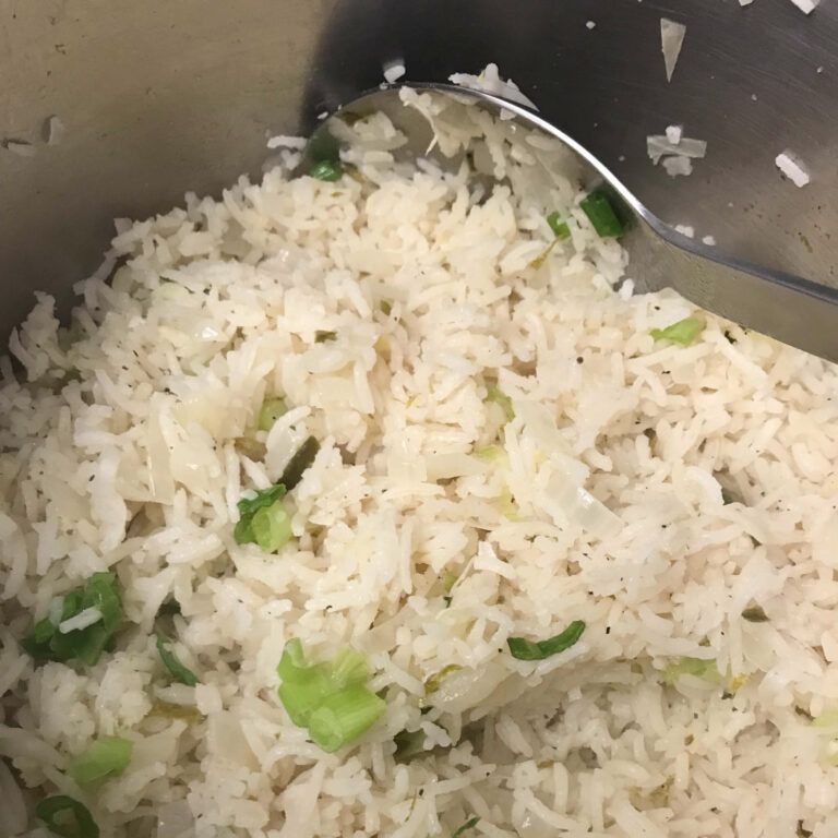 pot of cooked rice with green onions added