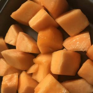 cut cantaloupe on a baking sheet