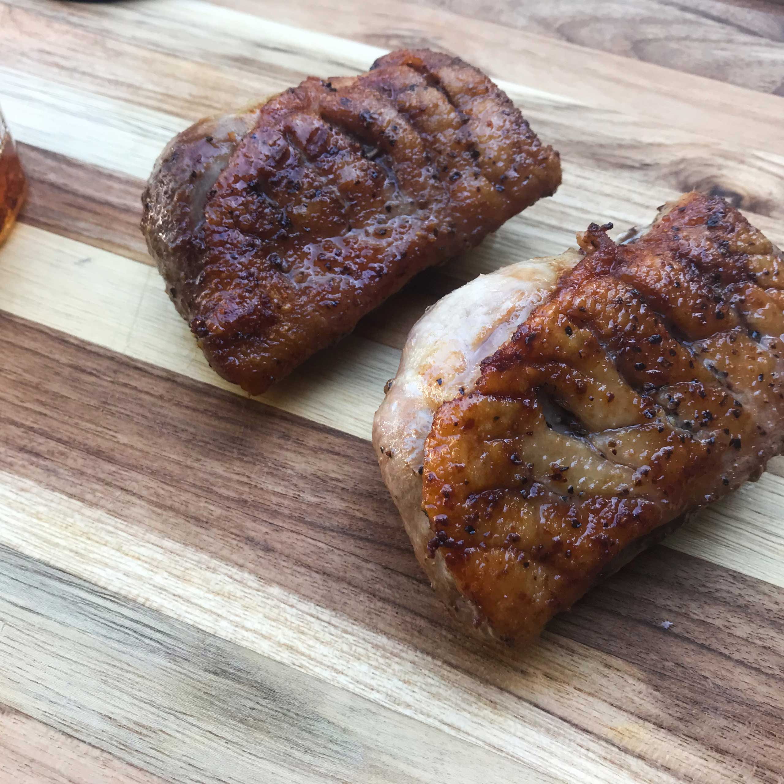 cooked duck breast resting on cutting board